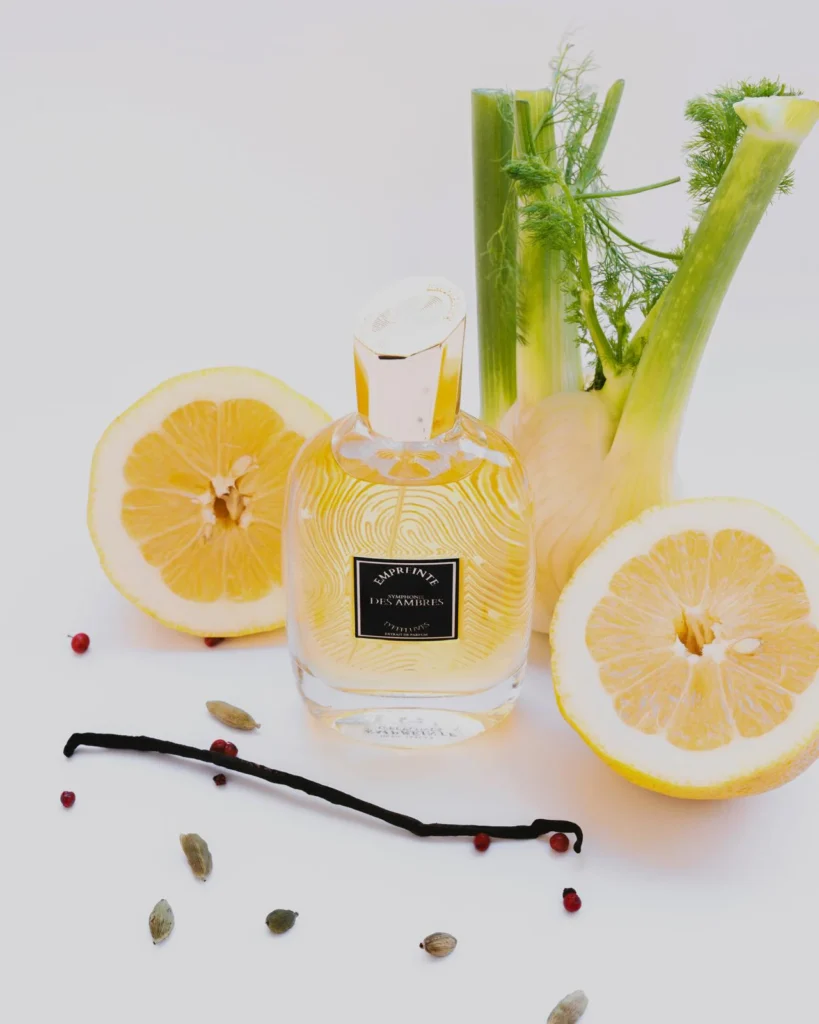 Flacon Symphonie des ambres entouré de céleri, de citron et de cardamome